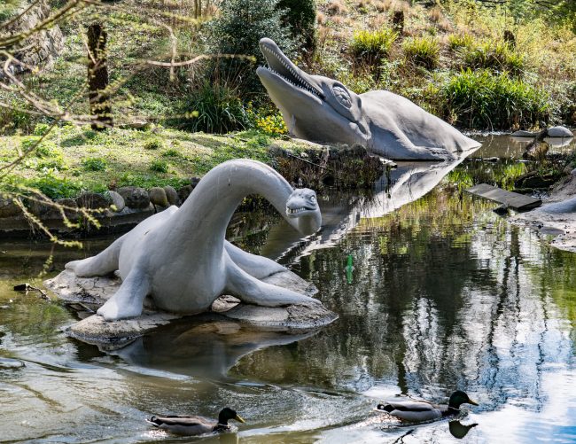 OLYMPUS DIGITAL CAMERA Ichthyosaurus communis and ‘Plesiosaurus’ macrocephalus statues in the water at Crystal Palace Park
